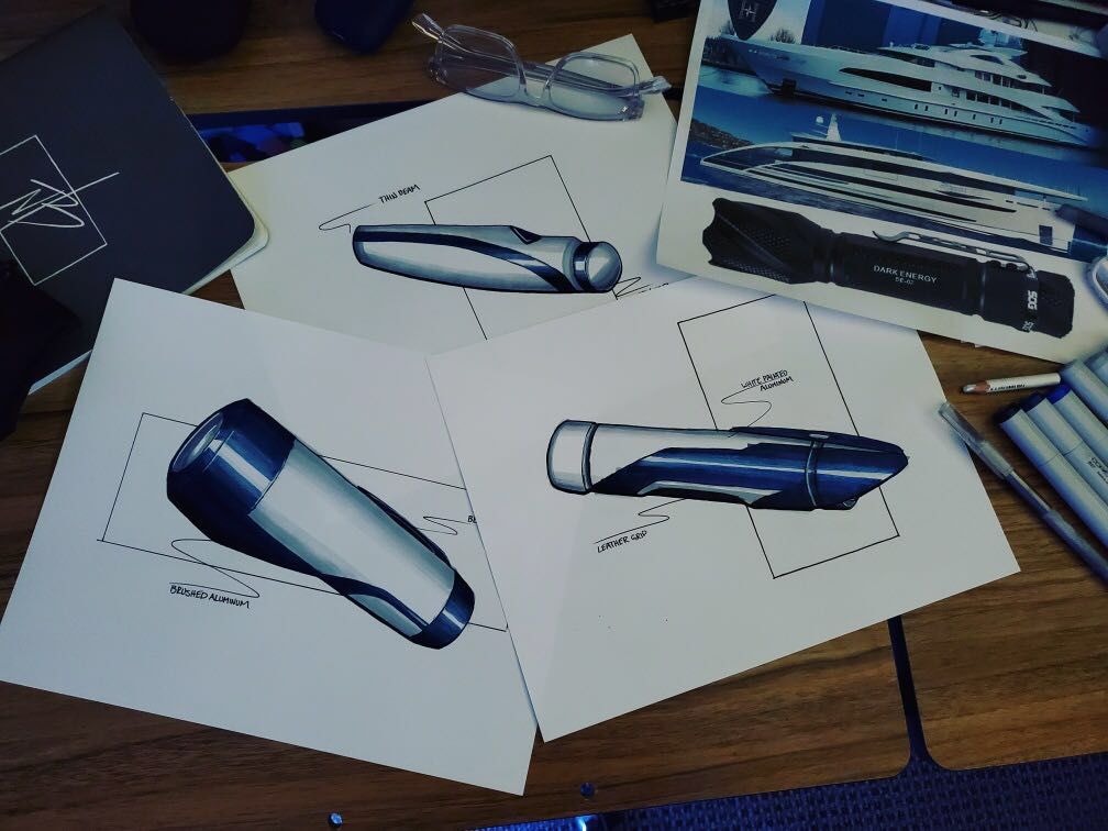 A piece of paper includes three sketches of an aluminum flashlight drawn in ink